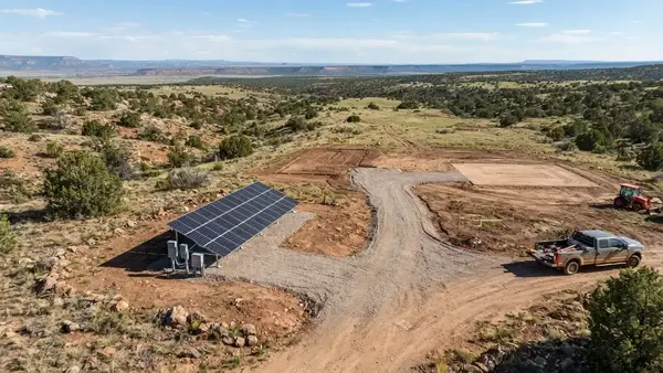 Ground-mounted off-grid solar array planned alongside future home driveway well septic system and outbuildings on rural Apache County property