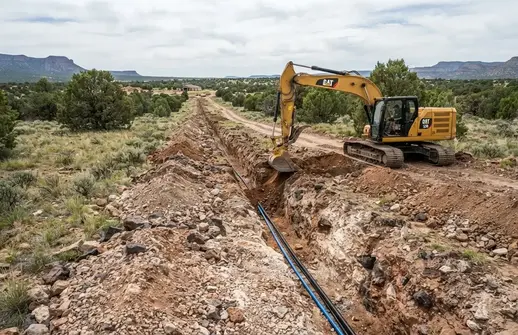 Utility trench excavation for underground electrical and water lines on a rural property in Apache County Arizona
