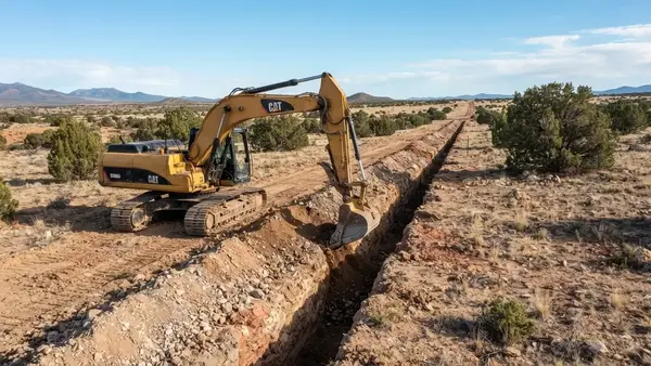 Utility trench excavation through rural Apache County Arizona terrain