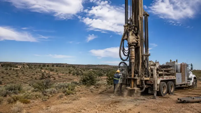 Water well drilling rig working on a rural property in Apache County Arizona
