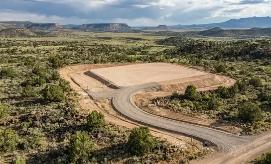 Complete rural property development including grading, drainage, utility trenching, and building pad preparation in Apache County Arizona
